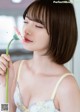 A woman holding a flower in her hand. 