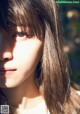 A close up of a woman with long brown hair.